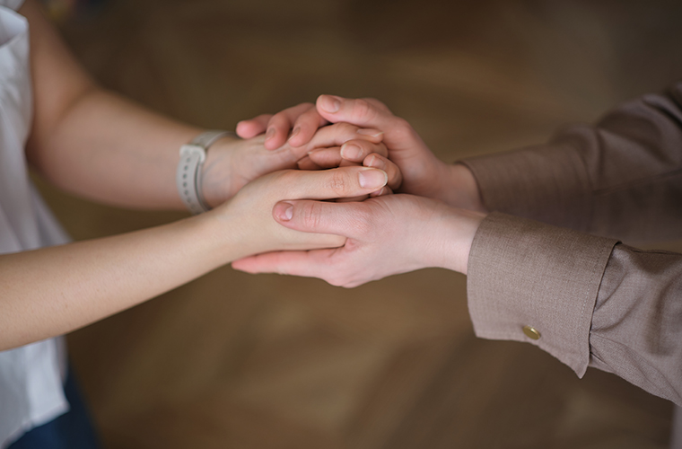 Two people holding hands