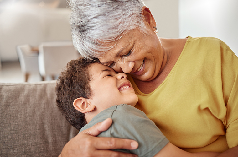 Happy family, child and grandma hug and bond in living room together, happy and content in their home. Relax, smile and love of boy hugging senior woman showing love and having fun